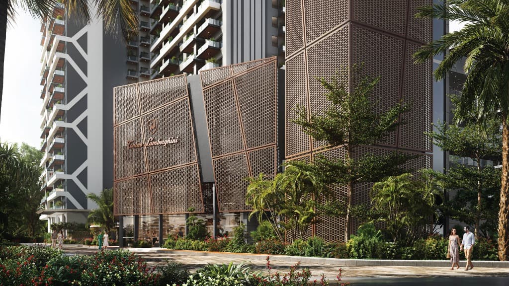 Tonino Lamborghini Residences Gurugram - Gold mesh facade entrance with side landscaped pathway